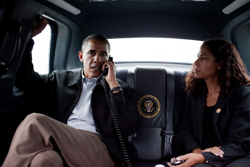 Deputy Chief of Staff for Policy Mona Sutphen looks on as President Barack Obama talks on the phone with California Gov. Arnold Schwarzenegger while in the motorcade during a trip to Richmond, Va., Sept. 29, 2010. Official White House Photo by Pete Souza